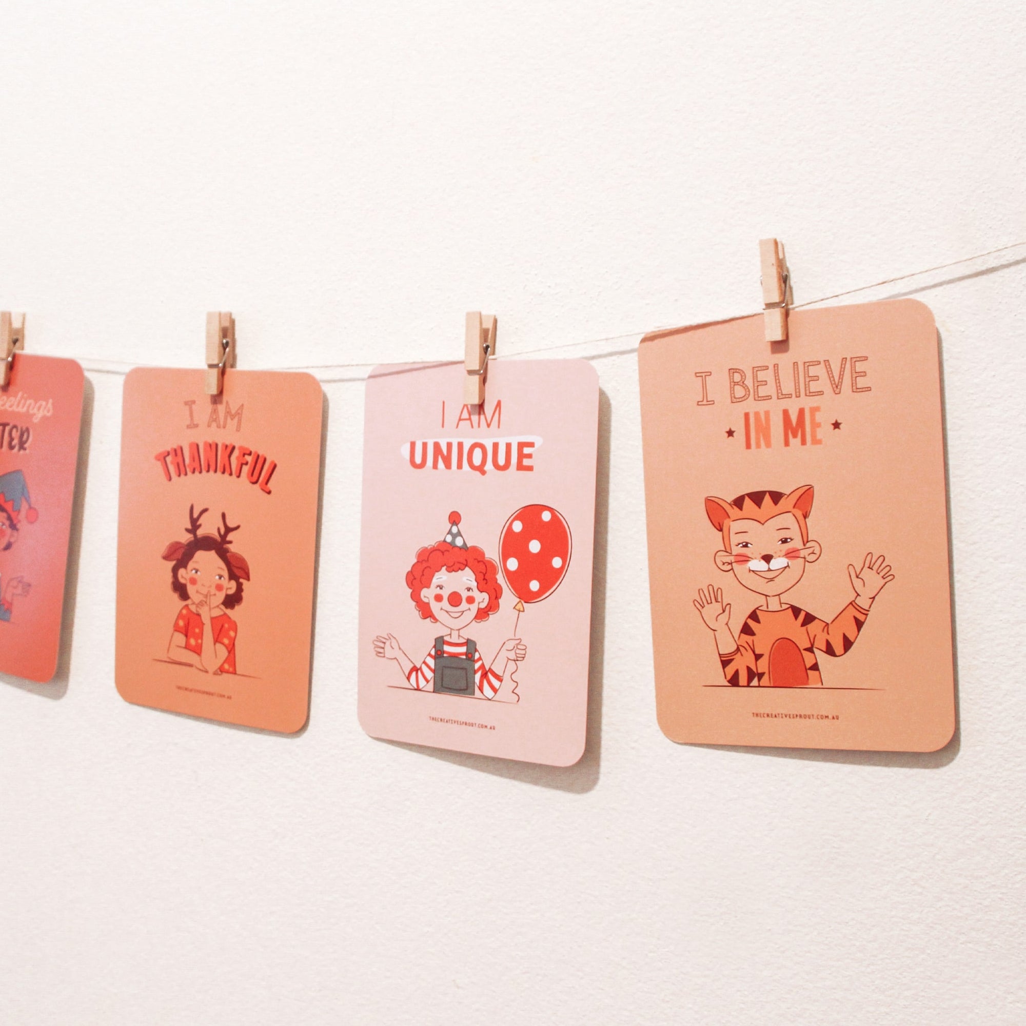 string hanging across a wall with affirmation cards for kids