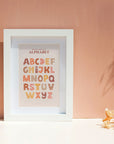 boho bedroom with framed alphabet poster