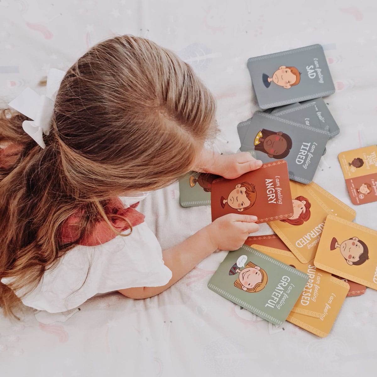 child with zones of regulation cards