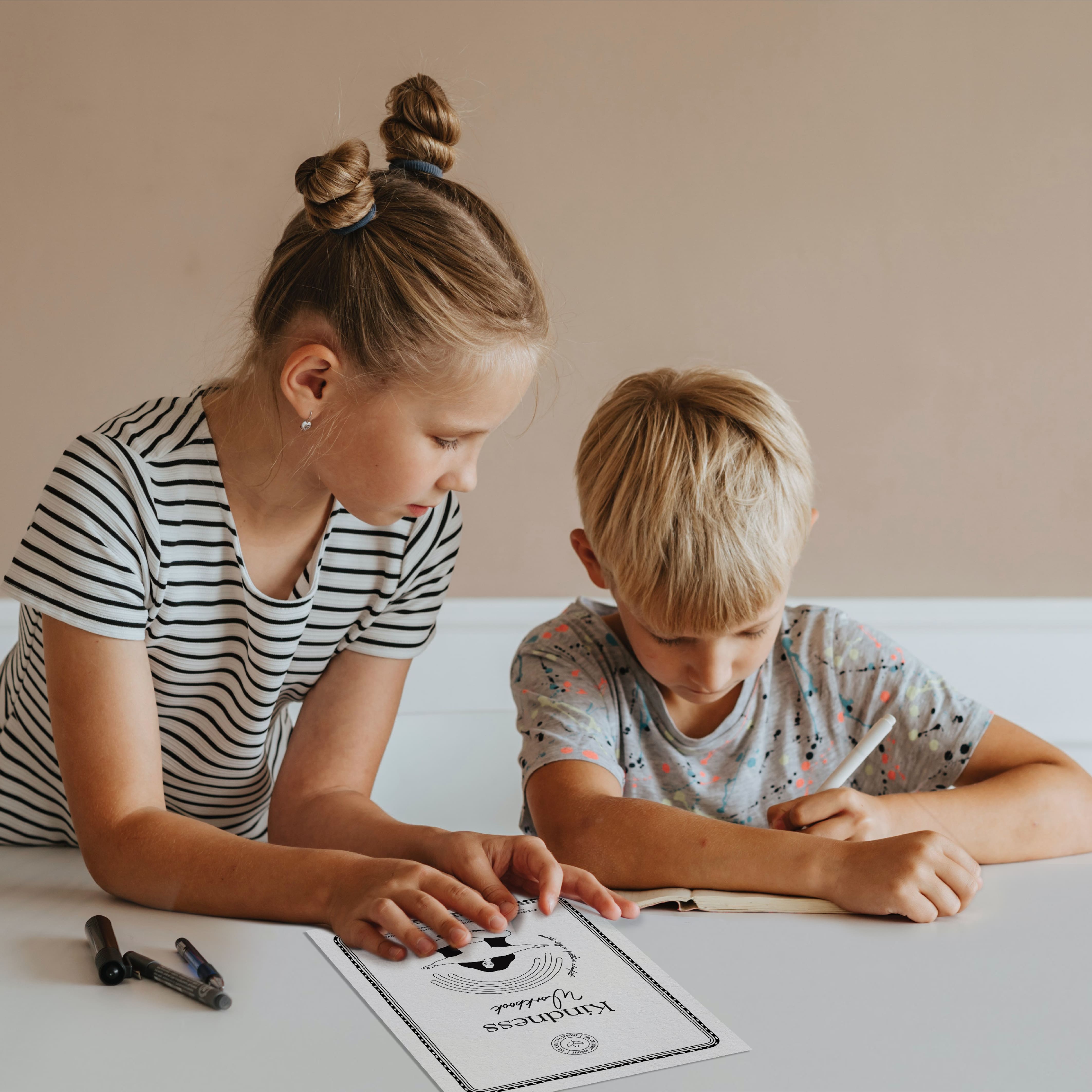 two young children working on gratitude worksheets